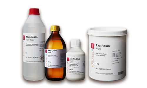 A range of Aka-Resin products by Akasel, including Aka-Resin Liquid Epoxy 1 liter, Aka-Cure Quick 500 ml, Aka-NoStick Liquid, and Aka-Resin Acrylic 1 kg, representing high-quality solutions for metallographic mounting processes.