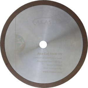 Akasel diamond cut-off wheel Aka-Cut 1500 HV, 150 mm, with a shiny silver metallic finish and a brown outer rim. The disc displays inscriptions such as "Aka-Cut 1500 HV", "CBN cut-off wheel, resin bond", "Recommended: 3200 rpm", "Batch: C2024416", "Store clean and dry", and the website address "www.akasel.com". A central hole is included for mounting.