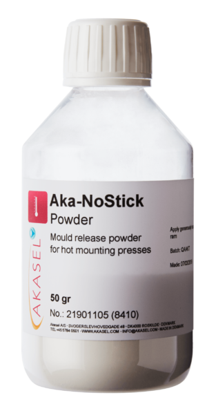 Akasel Aka-NoStick Powder in a transparent plastic bottle with a white screw cap. The label displays the product name "Aka-NoStick Powder" and the description "Mould release powder for hot mounting presses." Additional details on the label: Contents 50 g, Article No. 21901105 (8410), made in Denmark. Specifically designed for metallographic hot mounting presses to ensure easy sample release.