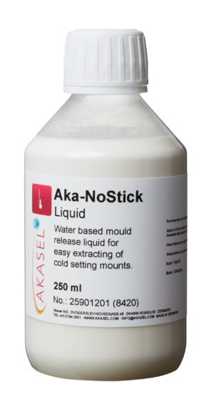 Akasel Aka-NoStick Liquid in a transparent plastic bottle with a white screw cap. The label displays the product name "Aka-NoStick Liquid" and the description "Water-based mould release liquid for easy extracting of cold-setting mounts." Additional details: Contents 250 ml, Article No. 25901201 (8420), made in Denmark. Specifically designed for metallographic applications to ensure easy removal of samples during cold mounting.